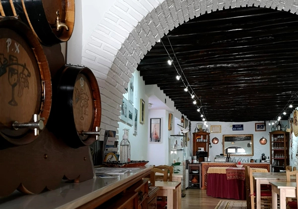 Restaurant van Casa rural la Seguiriya met wijnvaten op de achtergrond, in Alhama de Granada, Spanje